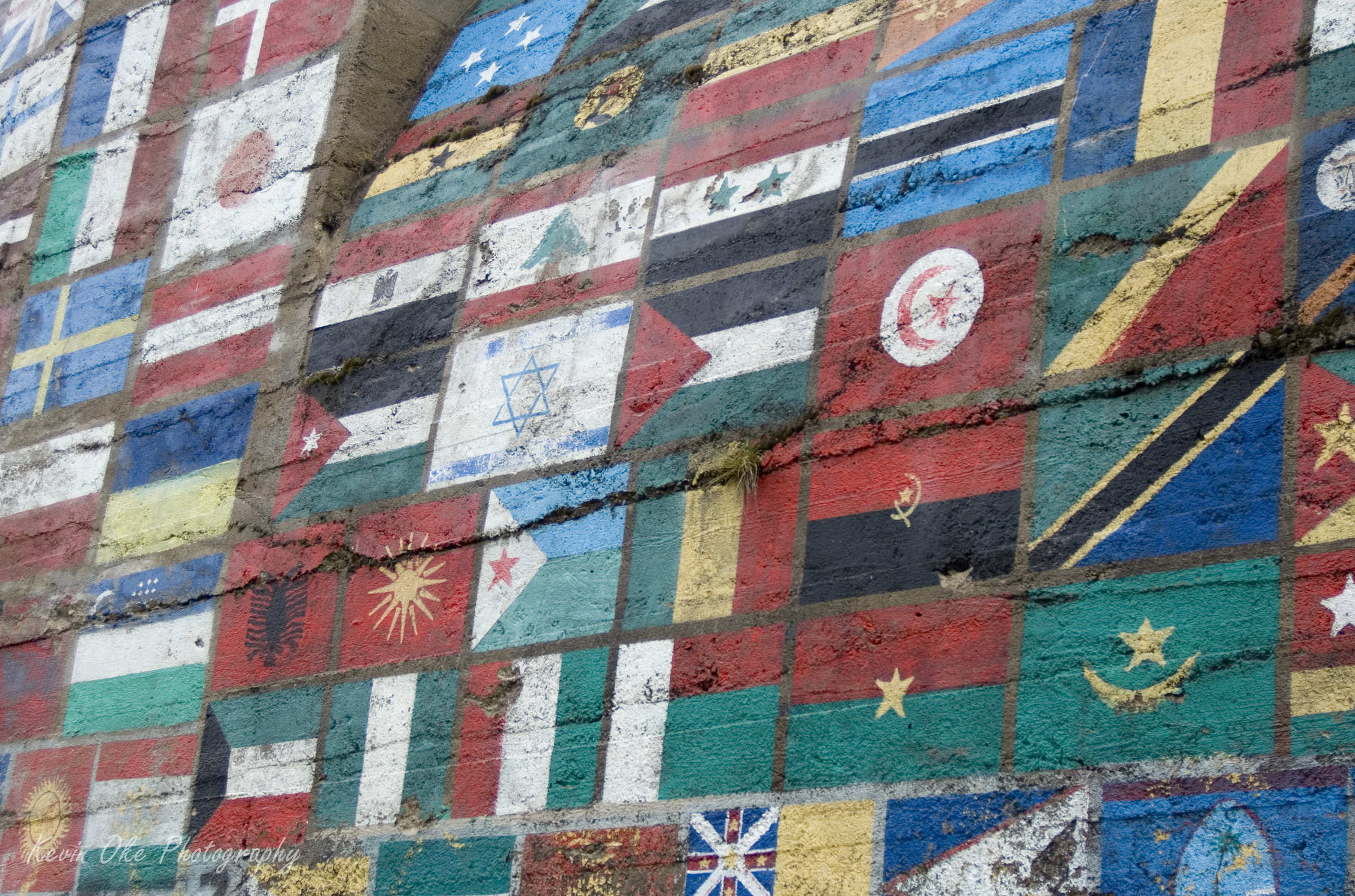 Old tunnel painted with flags, Greenwood, British Columbia